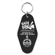 A black keychain with 'BADA BING GENTLEMEN'S CLUB' printed on it and the address 230 ROUTE 17 LODI, NEW JERSEY. There is also a graphic of a mobster and the number 6, referencing the show 'The Sopranos'.