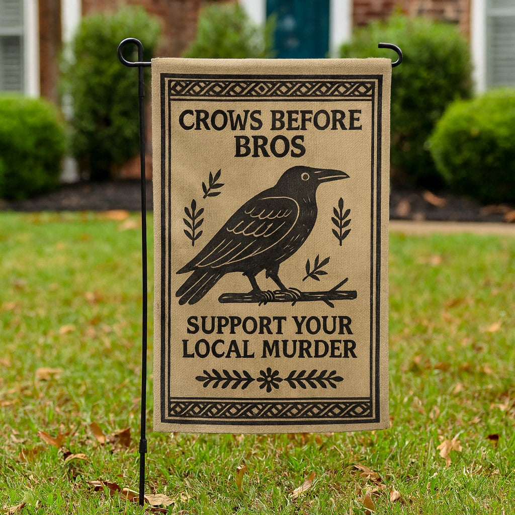 Garden flag with crow design and humorous text on a grassy background