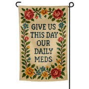 Decorative garden flag with floral design and text 'Give us this day our daily meds' on a white background.