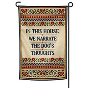 Decorative garden flag with text 'In this house we narrate the dog's thoughts' on a white background