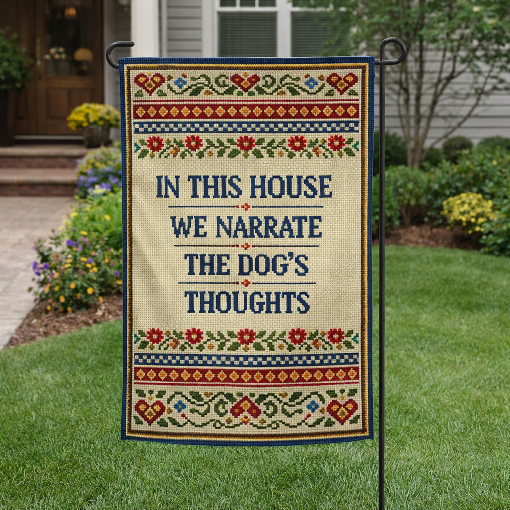 Decorative garden flag with text 'In this house we narrate the dog's thoughts' on a grassy lawn.