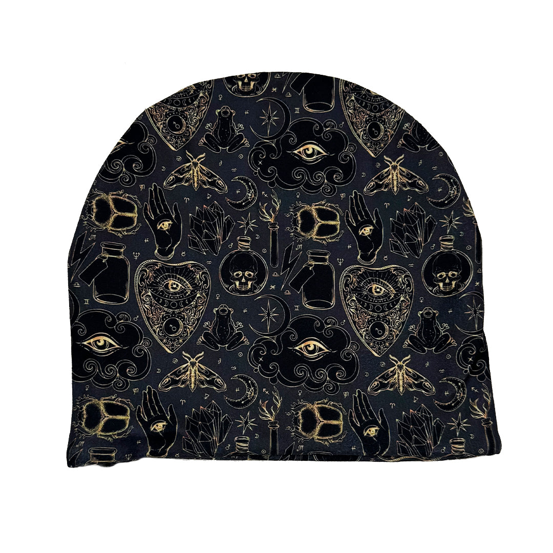 Black beanie with gold and black symbols on a white background