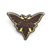 Moth-shaped enamel pin with a yellow border on a white background