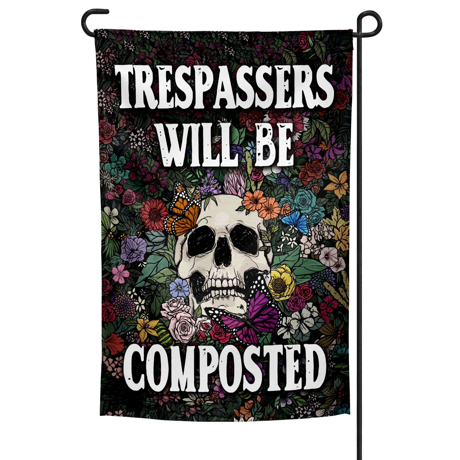 A garden flag with a skull and flowers design, featuring the text 'TRESPASSERS WILL BE COMPOSTED' on a black background.